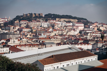 View of the Lisbon from the viewpoint Sao Pedro de Alcantara. Orange roofs of the old town. Travel photography.