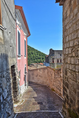 Fototapeta premium A narrow street between the old houses of the village of Faicchio in the province of Benevento, Italy