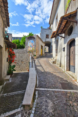 Obraz premium A narrow street between the old houses of the village of Faicchio in the province of Benevento, Italy