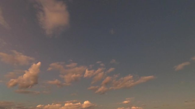Time lapse of orange red sky clouds at dusk sunset. Turning into dark night sky. New Zealand. 