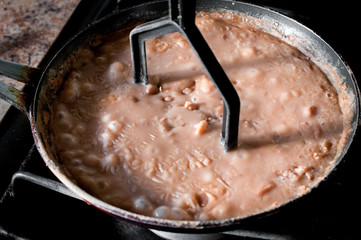 Mexican Frijoles Refritos or fried beans in a cooking pan, the ingredient in the Mexican food...