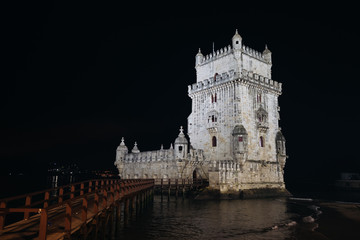 Fototapeta na wymiar Illuminated Belem Tower at night in Lisbon, Portugal