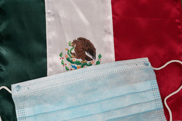 Close up of a Mexican flag and a face mask