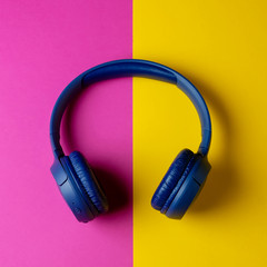 Headphones on a colorful yellow purple background. Webinar or podcast concept.