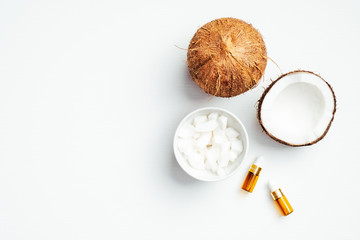 Coconut oil for skin care on white background top view, flat lay. Natural organic cosmetic product, spa treatment