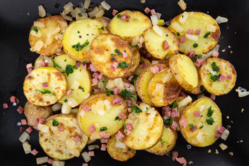 Portion of Fried Potatoes on an old wooden table (selective focus; close-up)