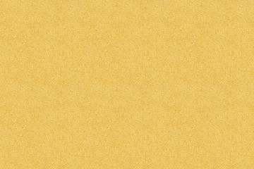 Fototapeta na wymiar Seamless texture of light yellow sand on the sea coast. Rectangular photo. Background for designer.