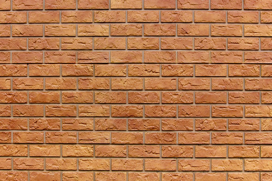 Brick texture. Orange background. Brown wallpaper for designer. Rectangular photo, image.
