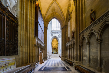 Fototapeta premium A section of the gothic interior of the medieval cathedral of Bayeux France with many vaults and a crucifix against the far wall