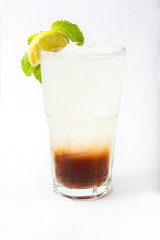 a glass of cola with lime and mint