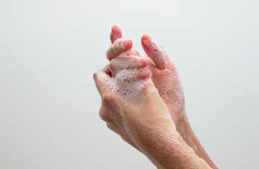 Fototapeta premium Washing hands with soap. Corona virus pandemic prevention wash hands with soap warm water and , rubbing nails and fingers washing frequently or using hand sanitizer gel