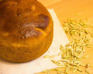 
Bread on a table with scattered oats