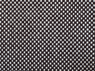 Black and white checkred woven material, texture or background.