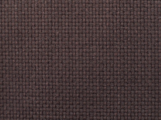 dark brown woven checkered fabric with visible texture. background or texture, closeup