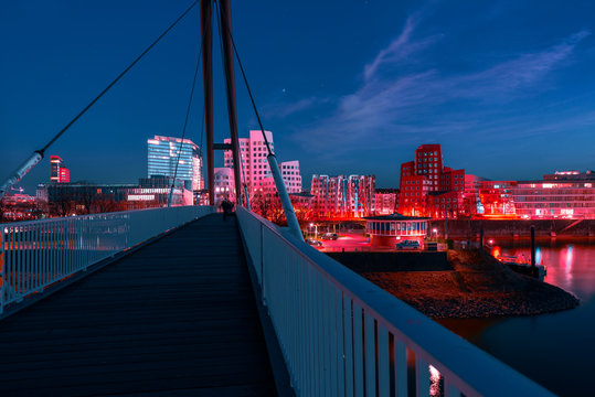 Diminishing Perspective Of Bridge Over River Against Sky In City At Night