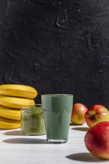 promotional shooting of a fruit cocktail for a healthy eating establishment. In the photo, a glass with a green drink made from fruits and algae spirulina powder