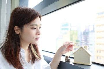 woman input money into the house saving