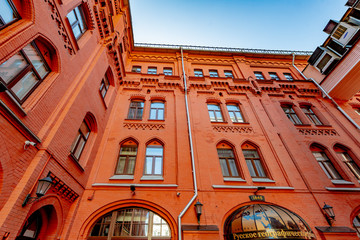 Facade of an old brick building with windows in Moscow on a clear day