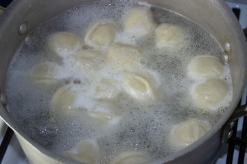 dumplings are cooked in a pot