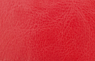 red leather with visible texture. background or texture, closeup.
