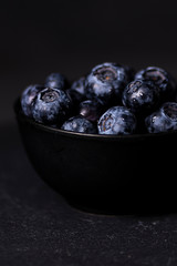 Fresh blueberry bowl. Dark food photography