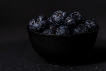 Fresh blueberry bowl. Dark food photography