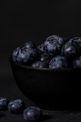 Fresh blueberry bowl. Dark food photography