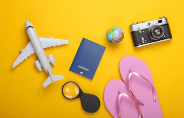 Summer beach and travel accessories on a yellow background. Tourism background. Flat lay. Top view