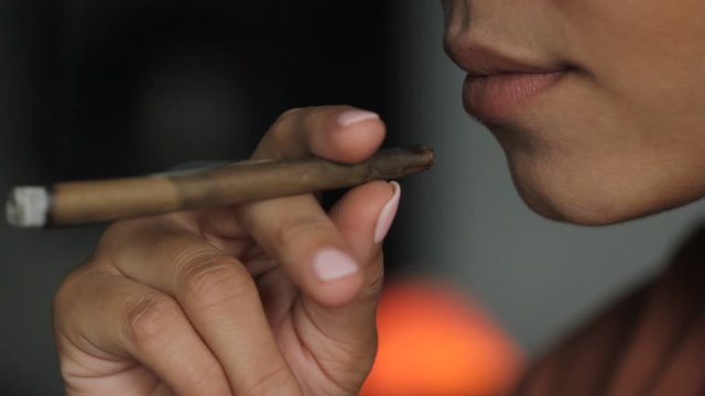 Profile of a woman smoking a blunt