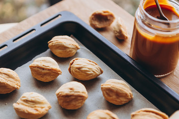 Homemade cookies with boiled condensed milk on a table background. Copy space