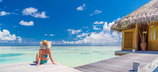 Vacation landscape blue sea banner luxury travel background woman relaxing by infinity sea view,...