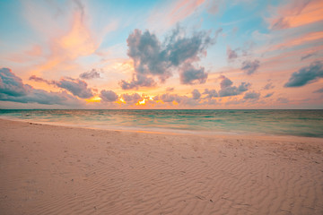 Fototapeta premium Sea sand sky concept, sunset colors clouds, peaceful horizontal background banner. Inspirational nature landscape, beautiful colors, wonderful scenery of tropical beach. Beach sunset, summer vacation 