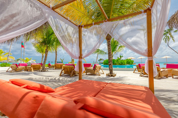 Fototapeta na wymiar White beach canopies. Luxury beach tents at a resort. Wonderful view of beach scenery, luxury vacation and travel background concept 