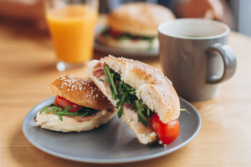 a large and mouthwatering bag-shaped sandwich with a delicate juicy stuffing on the coffee table. Breakfast for two in the instant cafe