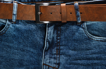 Brown leather belt with jeans close-up