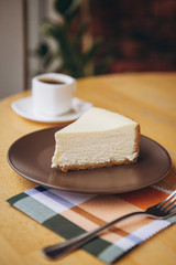 Piece of cake with coffee for breakfast on the table in a coffee shop