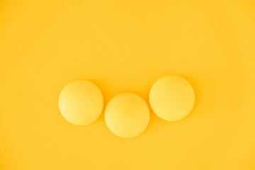 Yellow balls on yellow background. Minimal concept. Top view. Copy, empty space for text