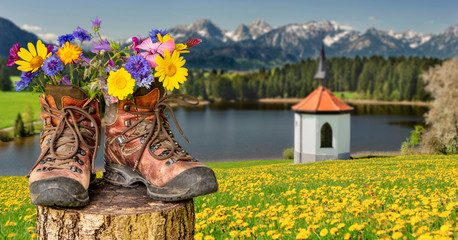 Walking shoes with flowers in a beautiful landscape