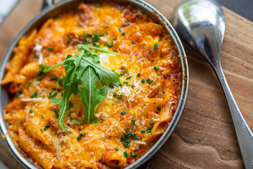 Italian pasta skillet dish. Tasty and delicious pasta meal is made with penne pasta, fresh tomato sauce and sausage. This italian inspired comfort food is cooked and served in a cast iron skillet

