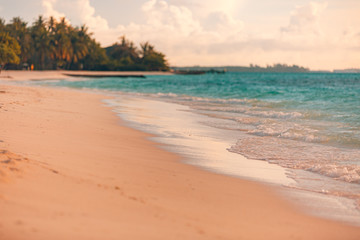Beautiful sunset on the tropical beach and sea landscape. Tropical beach with white sand and calm waves. relaxing exotic nature scenery