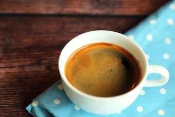 A cup of hot coffee on light blue fabric on wooden table, Hot espresso.