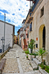 A narrow street between the old houses of a village in the province of Benevento, Italy