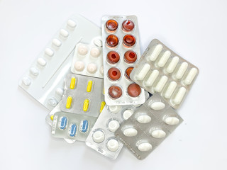 Many plenty a lot of tablets in blister pack, pills, capsules on a white background