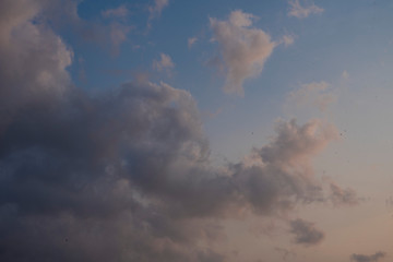 Beautiful clouds roaming in the red and bluish sky during sunset in the afternoon. Indian landscape and sky.