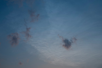 Beautiful clouds roaming in the red and bluish sky during sunset in the afternoon. Indian landscape and sky.