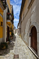 A narrow street between the old houses of a village in the province of Benevento, Italy