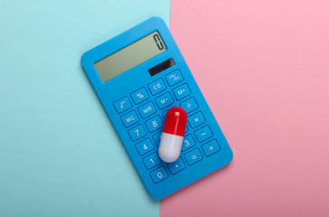 Calculation of the cost of medical expenses. Calculator and pill on a blue-pink pastel background....