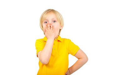 Surprised boy closes his mouth with his hand