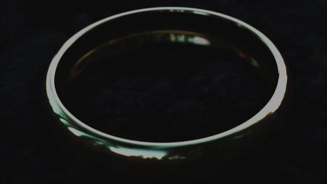 A Golden ring on which text and smoke appear. 3D render.