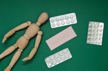 Joint pain forearm. The wooden man is holding his hand over his forearm in red. medical preparations